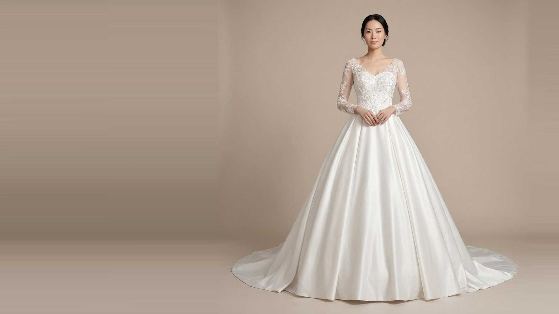 A satin ball gown wedding dress with lace sleeves from the collection