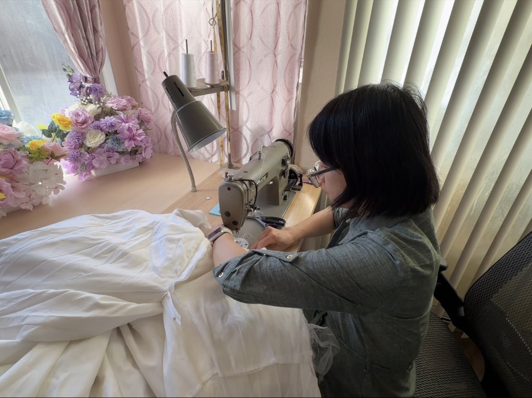 The seamstress working at her sewing machine